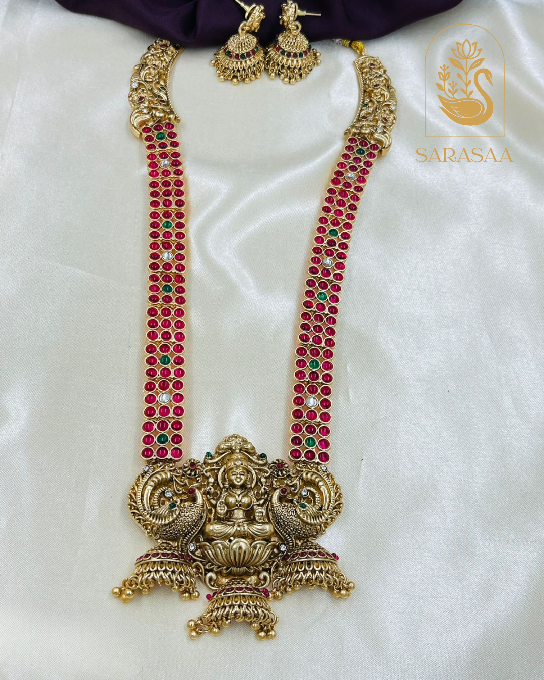 Sarasaa Traditional Matte Gold-Plated Lakshmi Temple Long Necklace Set with Ruby & Green Stones and Jhumka Earrings