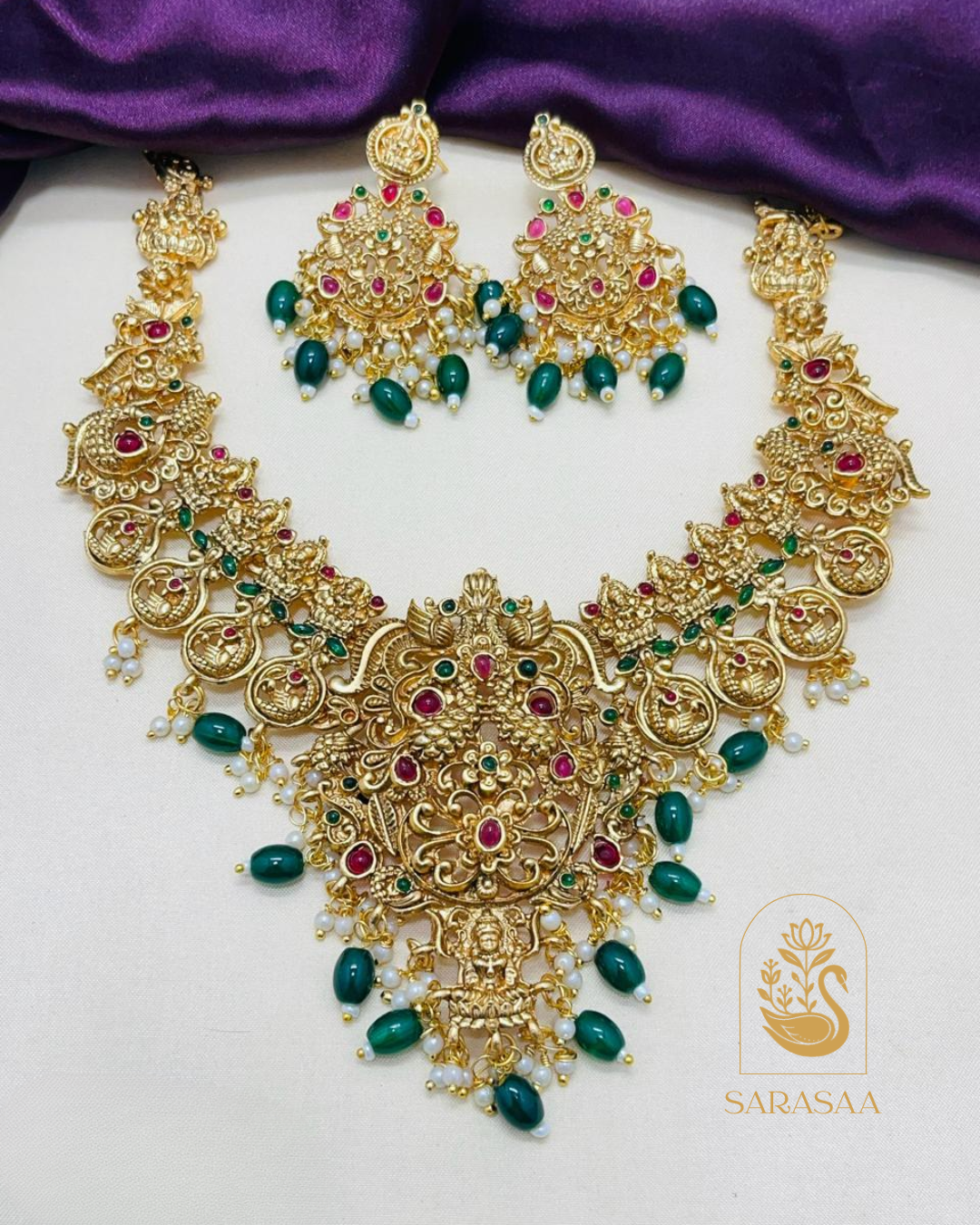 Sarasaa Traditional Gold-Plated Lakshmi Peacock Short Temple Necklace Set with Ruby & Emerald Kemp Stones and Green Beads