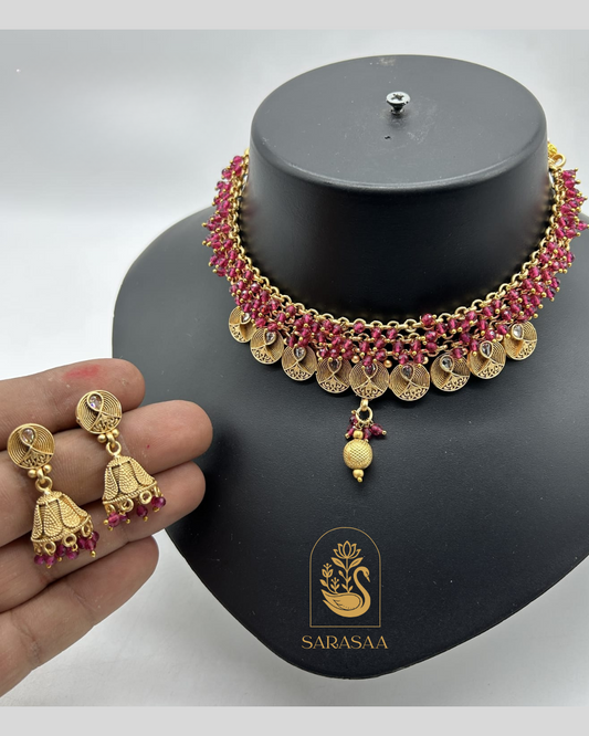 Sarasaa Gold-Plated Kundan Hasli Necklace Set with Ruby Stone Accents and Matching Jhumka Earrings